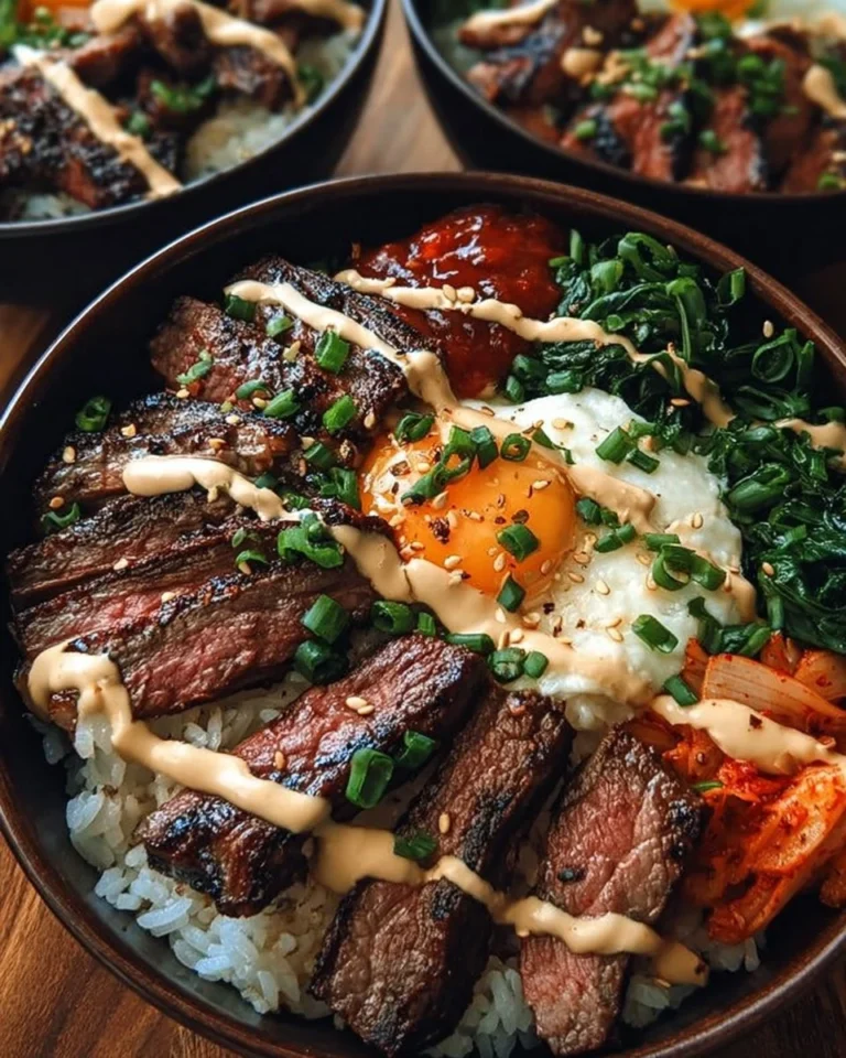 Korean BBQ steak rice bowls topped with vegetables and sauce
