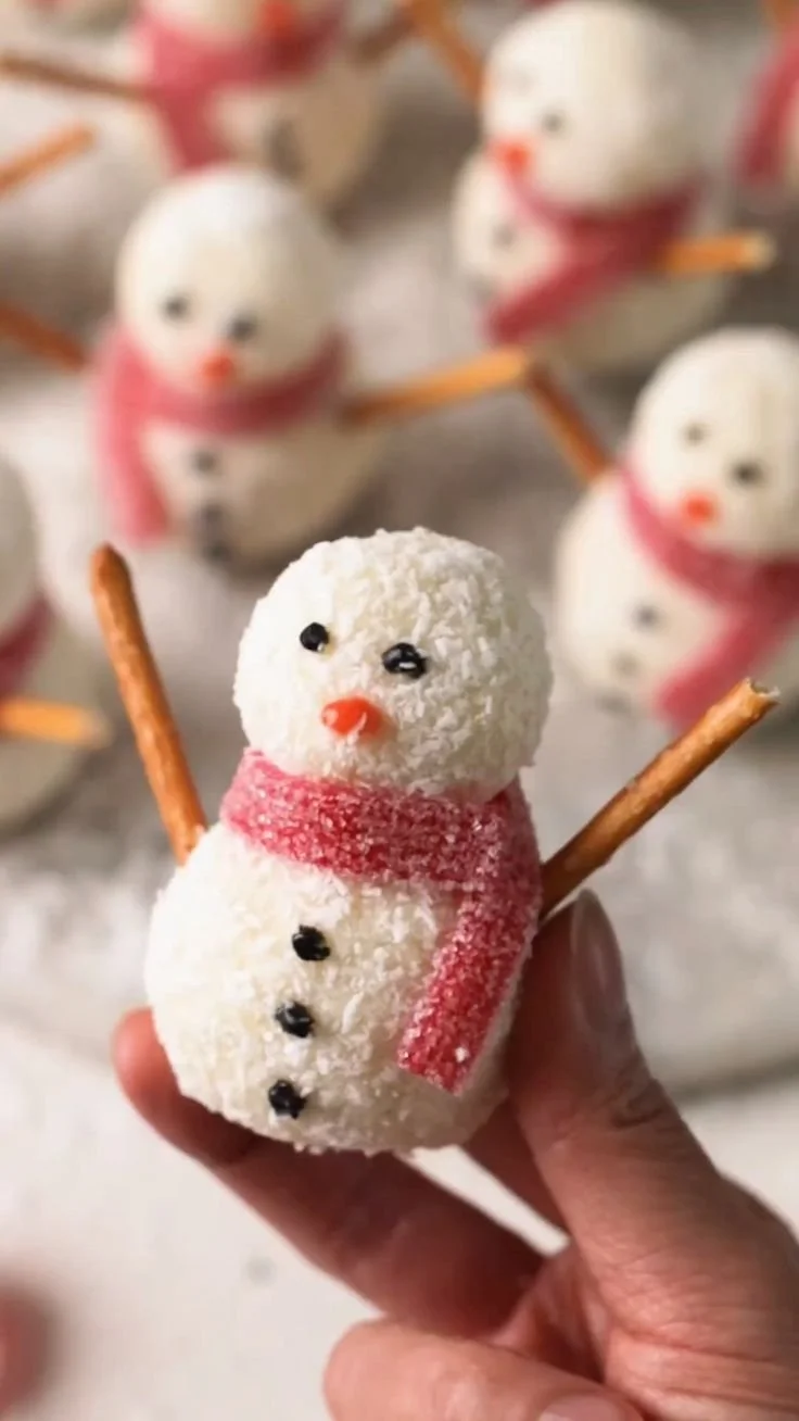 Cute snowmen truffles decorated for the holidays, perfect no-bake treats.